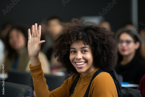 Young woman raising hand in a classroom setting, engaging with the teacher, diverse students in the background.