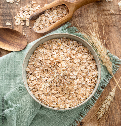 Bowl of wheat flakes on wooden table. Top view. Rural concept. Top view. photo