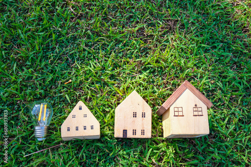 Wooden house toy on greenmeadow grass real etate photo