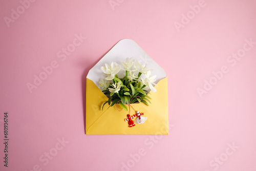 Martenitsa, Martisor with flowers in an envelope on a pink background flat lay copy space photo