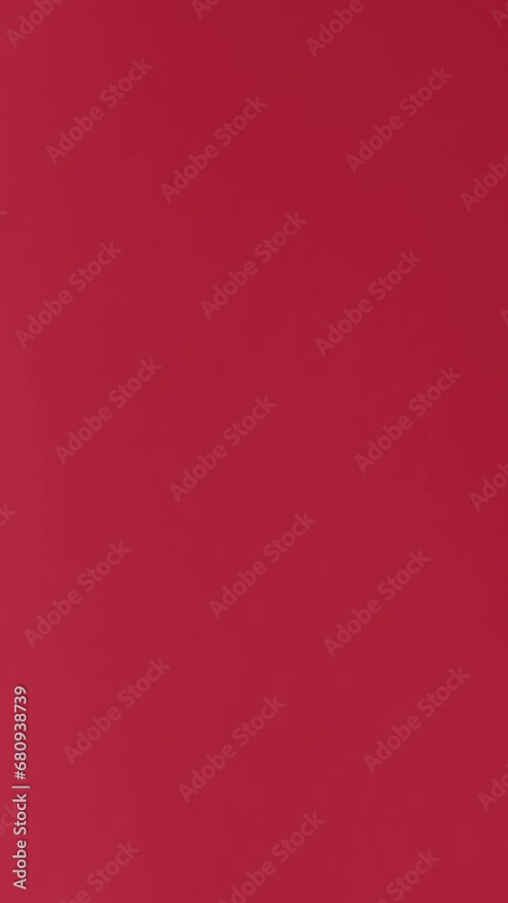 Vertical video. Gift delivery. Special offer. Hands in blue protective gloves showing present in white present box with ribbon bow isolated on red background. Vertical video. Gift delivery. Special offer. Hands in blue protective gloves showing present in white present box with ribbon bow isolated on red background.
