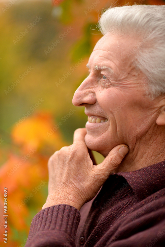 Close-up portrait of smiling senior man in park Close-up portrait of smiling senior man in park