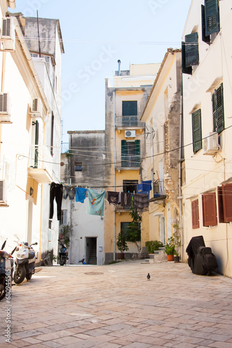 Corfu street with motorcycles and clothes in an authentic area, Corfu © Igor Nemytyshev
