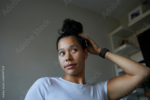 Woman lookinng in the mirror to check how her hair looks in a bun