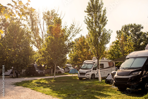 camping life with motorhomes and cars and tents in the early morning. travel and vacation by car