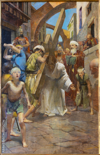 TREVISO, ITALY - NOVEMBER 8, 2023: The painting  Simon of Cyrene helps Jesus carry the cross as part of Cross way stations in the church La Cattedrale di San Pietro Apostolo by Alessandro Pomi (1947). photo