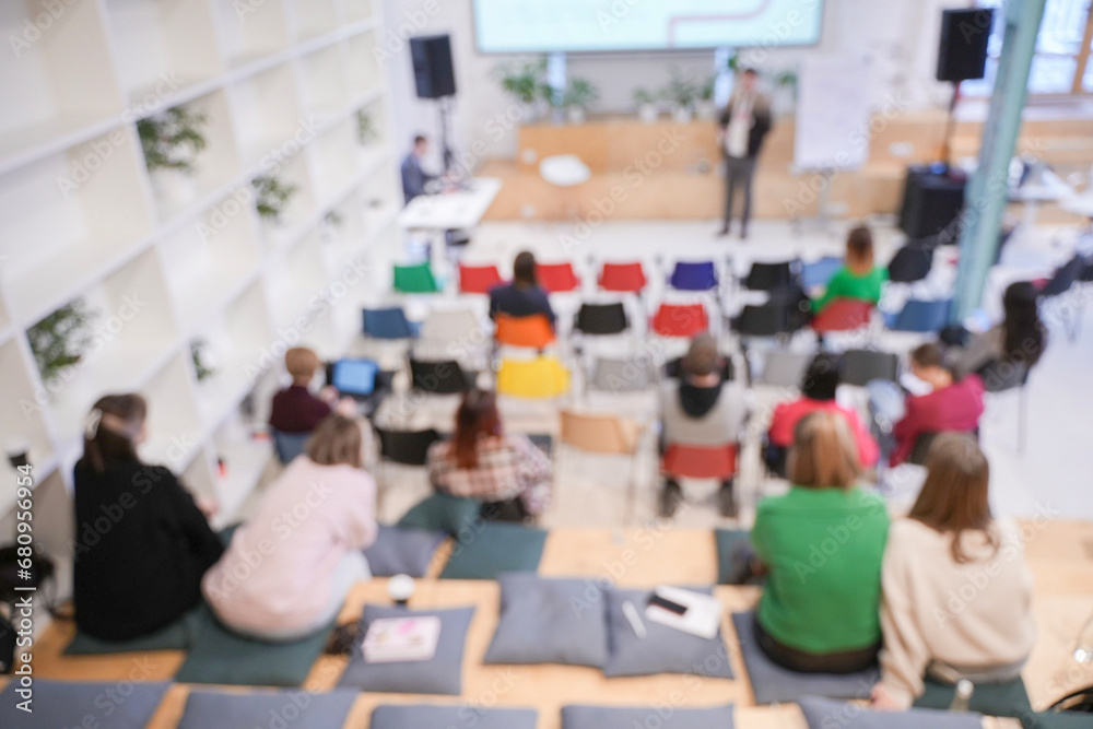 Male speaker at a conference, seminar, lecture. Personal growth training or business training. People's faces are not visible in the photo. Blurred. High quality photo Male speaker at a conference, seminar, lecture. Personal growth training or business training. People's faces are not visible in the photo. Blurred. High quality photo