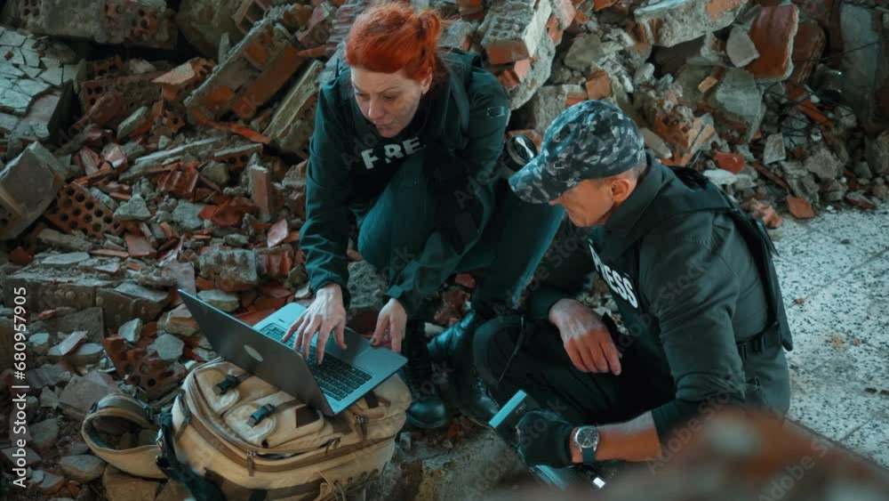 Journalists with a laptop and camera in a war zone. Sequences fotage Journalists with a laptop and camera in a war zone. Sequences fotage
