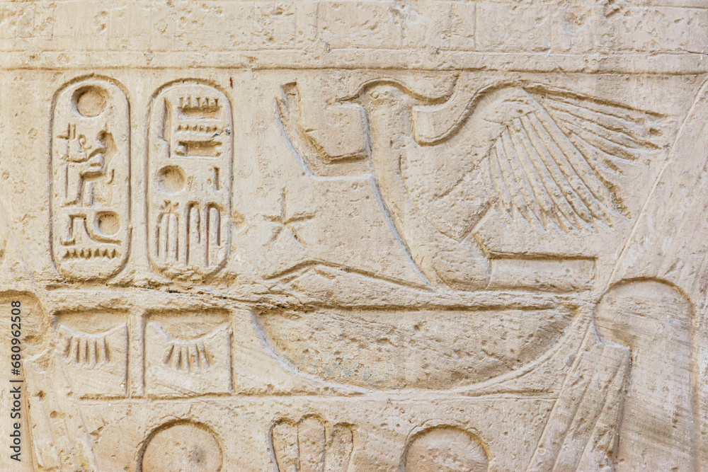 Carved Egyptian hieroglyphs at the wall of Karnak Temple. Close-up fragment, , Luxor, Egypt. History, tourism or art history concept