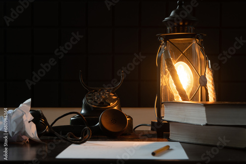 Vintage lamp and telephone. A study with rarities. A cozy atmospheric photo that transports us to another century
