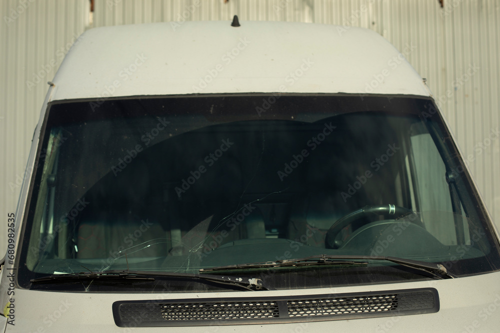 Car in front of parking lot. Car windshield. White machine. Car in front of parking lot. Car windshield. White machine.