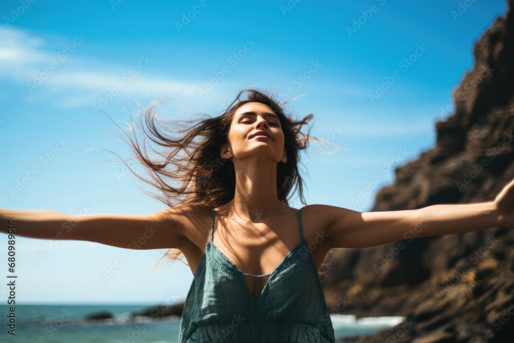 A woman enjoying the fresh air on the sea coast