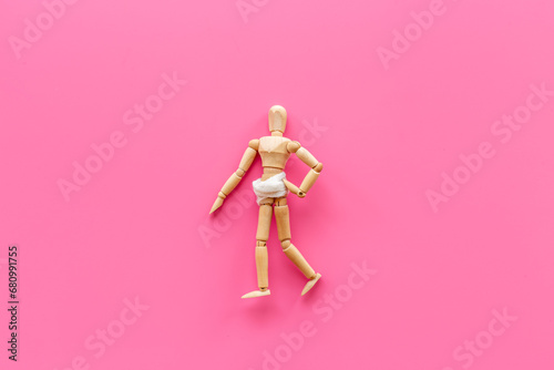 Wooden dummy man with stomach in bandage. Medical insurance and healthcare concept