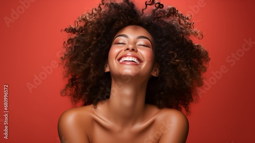 A portrait of a beautiful smiling happy African woman. Red background