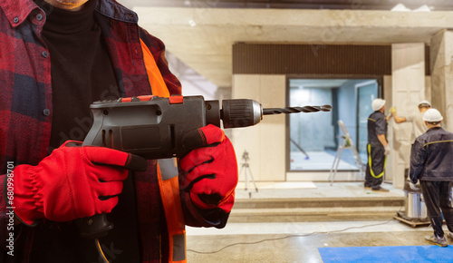 Electric drill in hands of ...