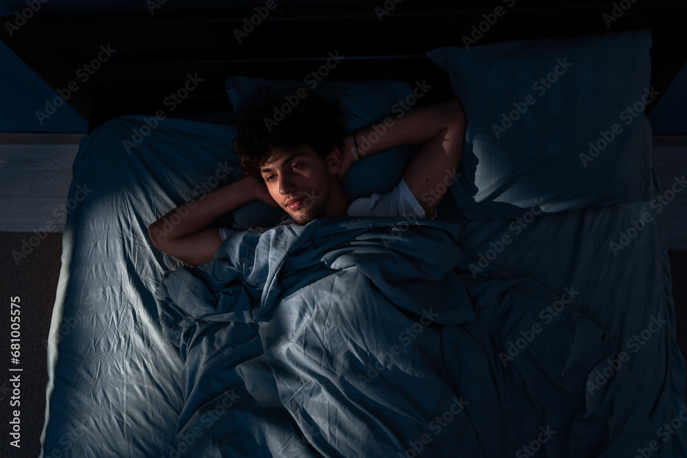 Arabic young man lying in bed cannot sleep from insomnia. unable sleep. Restless people. Arabic young man lying in bed cannot sleep from insomnia. unable sleep. Restless people.