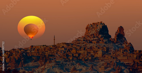 Hot air balloon flying over spectacular Cappadocia at dusk - Goreme, Turkey