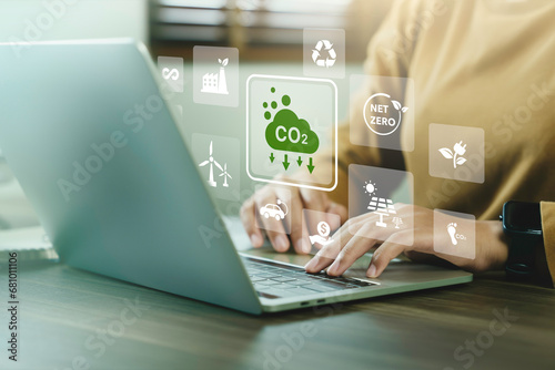 Company use computer report results to reduce CO2 emissions carbon footprint climate change and Net zero to limit global warming. Sustainable development and innovation green business concept. photo