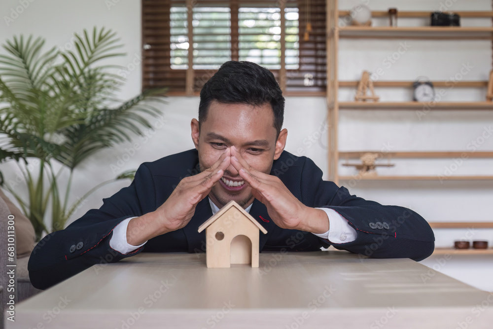 Obraz premium Real estate concept, businessman holds house icon. House in hand. Property insurance and security concept. and the symbol of the house