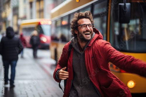 A happy man is stopping a bus on a city street photo