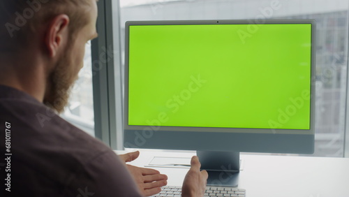 Student talking mockup device online indoors closeup. Man using chroma key pc