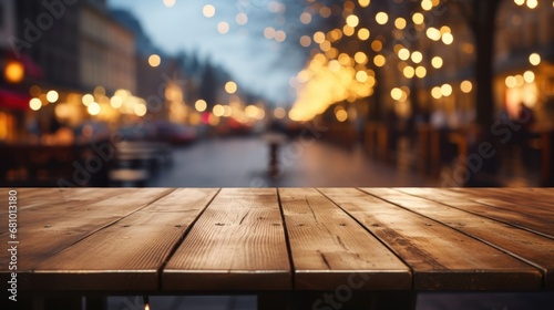 Wooden table top with blurred Christmas city bokeh lights background.