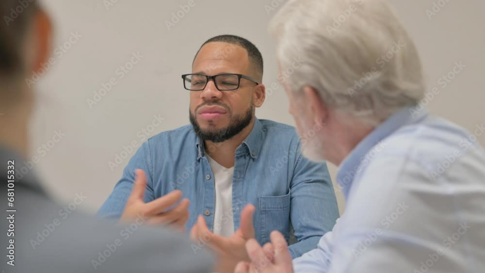 Close up of Hispanic Man Talking with Teammates Close up of Hispanic Man Talking with Teammates