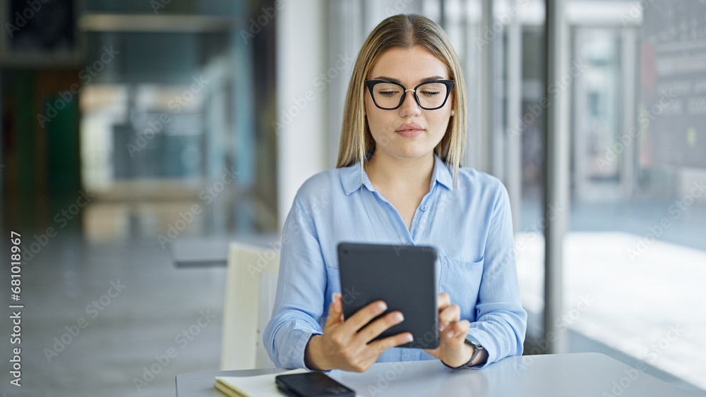 Young blonde woman business worker using touchpad at office Young blonde woman business worker using touchpad at office