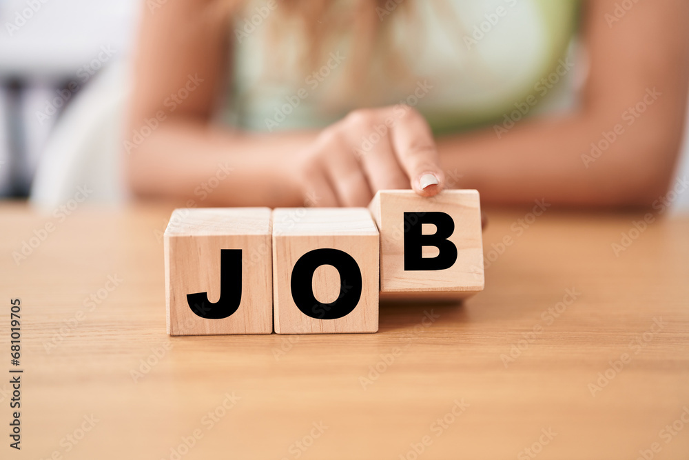 Fototapeta premium Young woman holding cubes with job word on the table