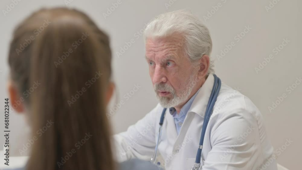 Rear View of Senior Doctor Talking with Patient Rear View of Senior Doctor Talking with Patient