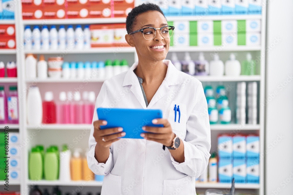African american woman pharmacist using touchpad working at pharmacy African american woman pharmacist using touchpad working at pharmacy