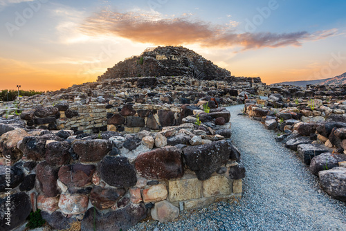 The bronze age fort UNESCO world heritage site Su Nuraxi di Barumini on Sardinia island during sunset.  photo