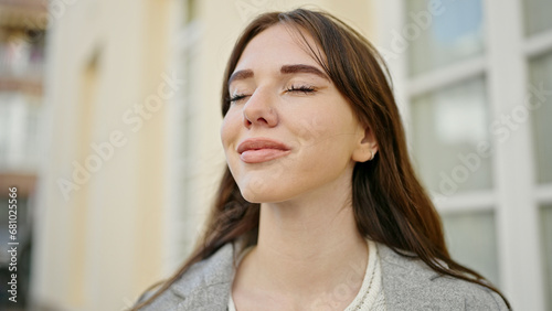 Young hispanic woman standing with closed eyes at street Free Download Young hispanic woman standing with closed eyes at street - GFXLoad