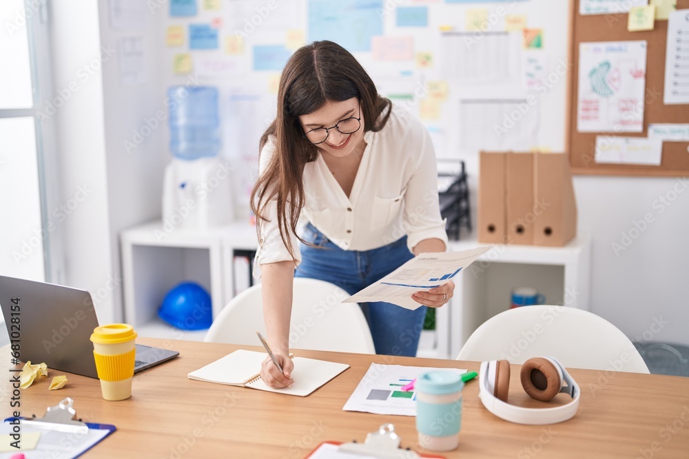 Young caucasian woman business worker writing on document at office Young caucasian woman business worker writing on document at office