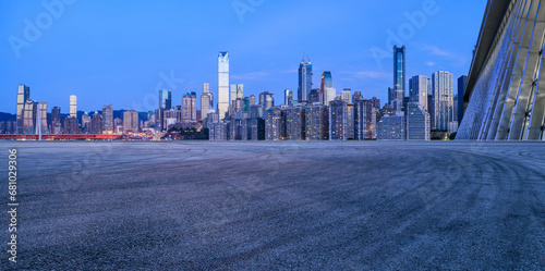 Asphalt road square and urban skyline with modern buildings at dusk in Chongqing, China.