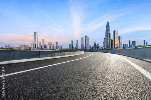 Asphalt highway road and urban skyline with modern buildings at sunrise in Shenzhen, Guangdong Province, China.