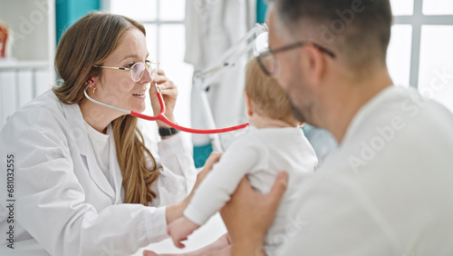 Hispanic father with baby on a doctor appointment at clinic