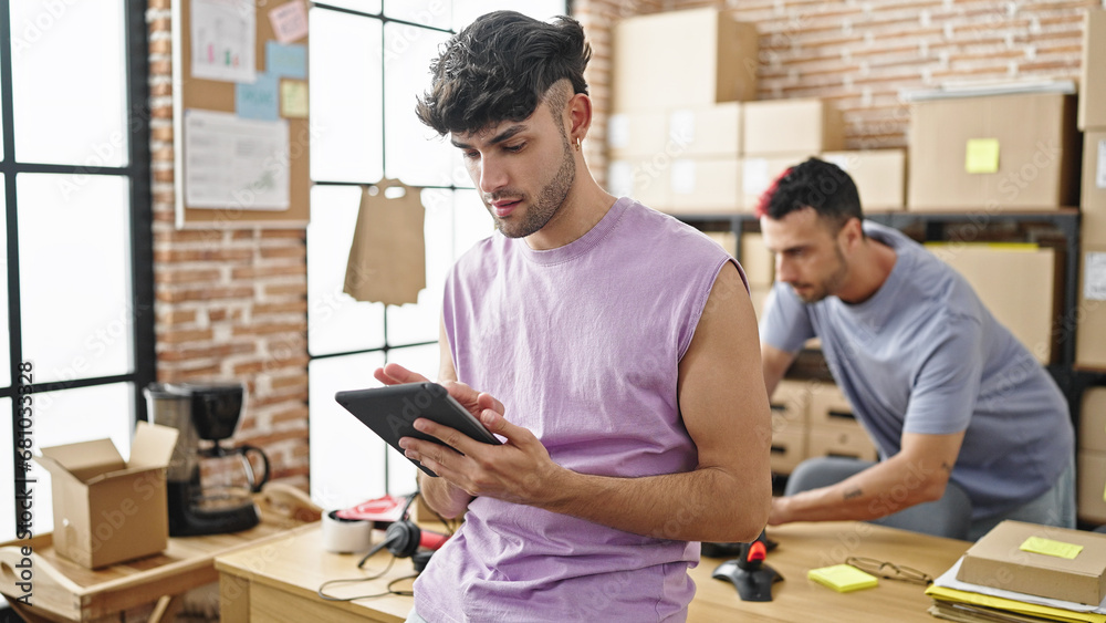 Two men ecommerce business workers using touchpad working at office Two men ecommerce business workers using touchpad working at office