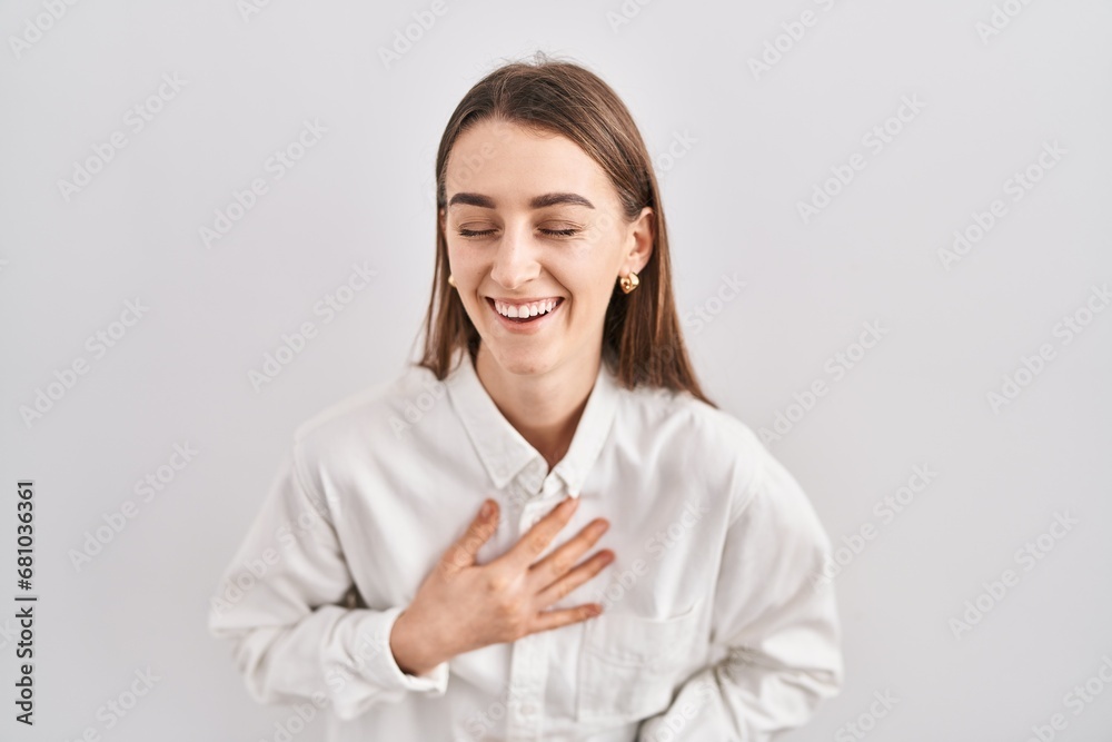 Young caucasian woman standing over isolated background smiling and laughing hard out loud because funny crazy joke with hands on body. Young caucasian woman standing over isolated background smiling and laughing hard out loud because funny crazy joke with hands on body.