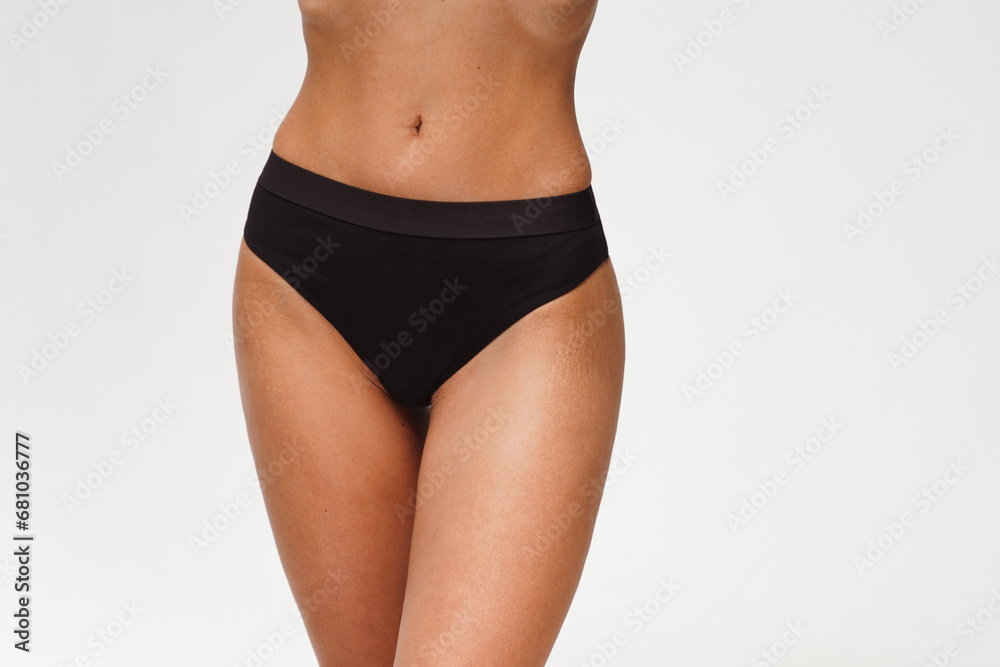 A woman with a beautiful feminine figure in black lingerie with overweight, cellulite and stretch marks. A woman with a beautiful feminine figure in black lingerie with overweight, cellulite and stretch marks.