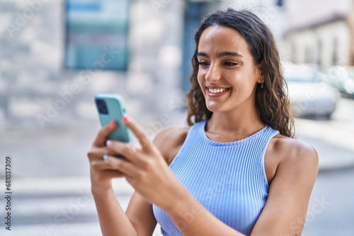 Young beautiful hispanic woman smiling confident using smartphone at street Free Download Young beautiful hispanic woman smiling confident using smartphone at street - GFXLoad