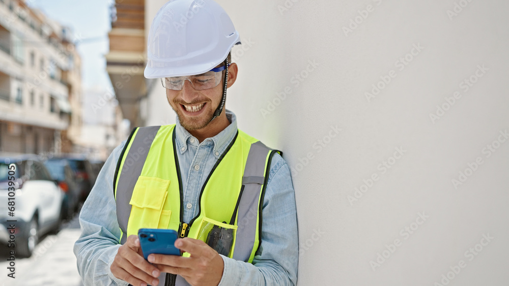 Young caucasian man architect smiling confident using smartphone at construction place Young caucasian man architect smiling confident using smartphone at construction place