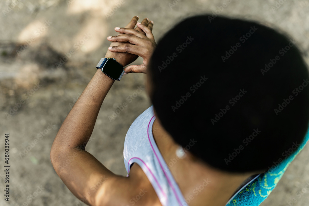 Fitness, sports and woman with smartwatch on wrist with mockup screen for health tracking app. Digital tech, exercise and girl check results for running, training and workout performance in park.