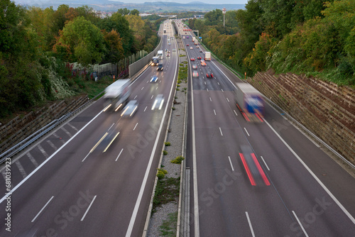 Long exposure photo of traffic with blurred traces from cars  top view. road  cars  blurred traffic  evening  top view. Highway at evening  blue hour illuminated by the traffic of cars