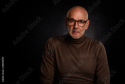 MId aged bald man wearing turtleneck sweater and glasses against isolated background