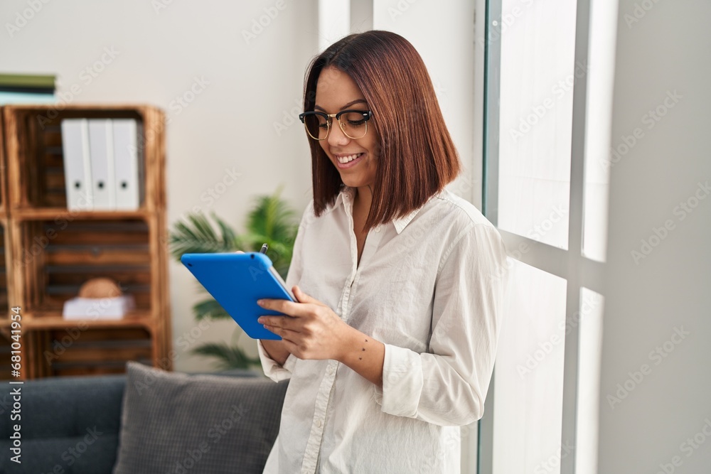 Young beautiful hispanic woman business worker smiling confident using touchpad at office Young beautiful hispanic woman business worker smiling confident using touchpad at office