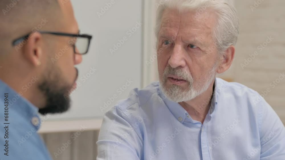 Close up of Old Businessman Talking with Young Man Close up of Old Businessman Talking with Young Man