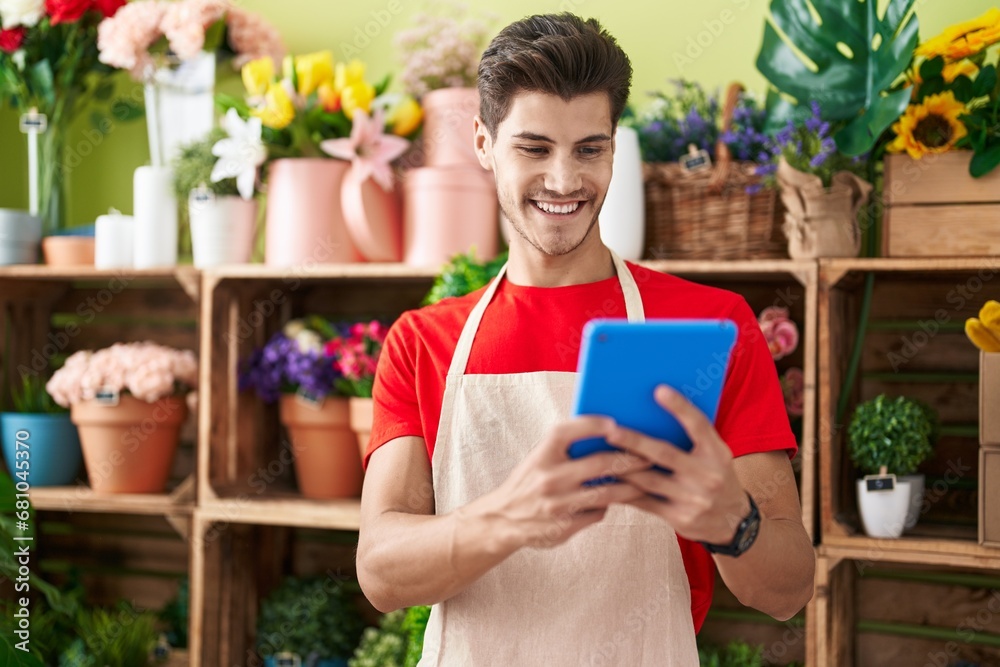 Young hispanic man florist smiling confident using touchpad at flower shop Young hispanic man florist smiling confident using touchpad at flower shop
