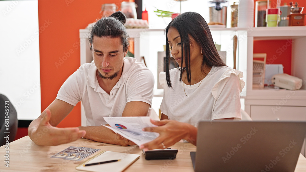 Man and woman couple using laptop accounting at dinning room Man and woman couple using laptop accounting at dinning room