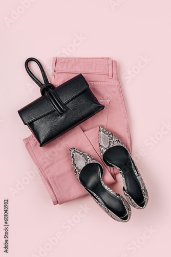 Pale pink jeans, heeled shoes and handbag. Fashion spring, summer or autumn outfit. Women's stylish and elegant clothes with accessory. Flat lay, top view, overhead.